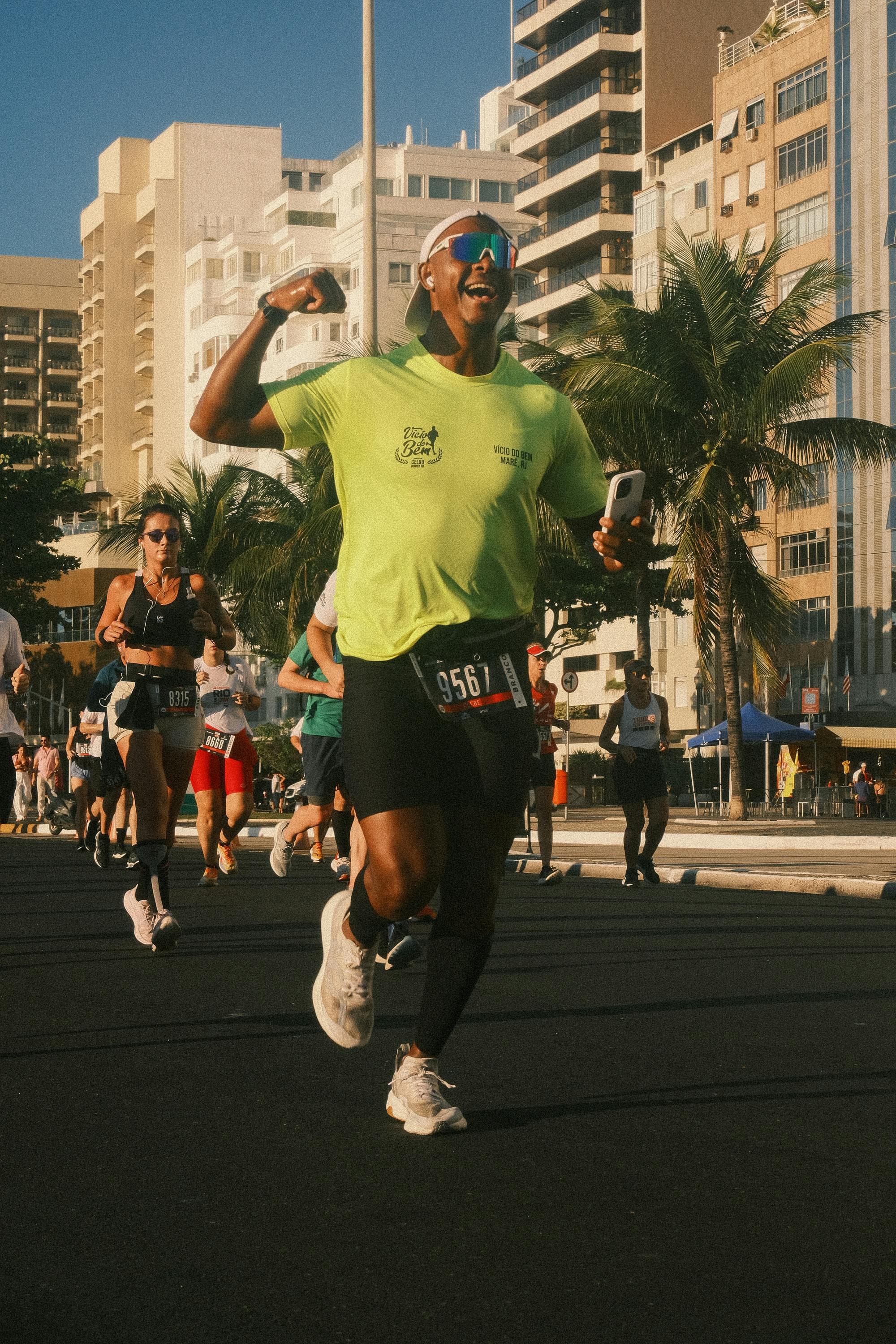 Runners competing through a sunny city road race