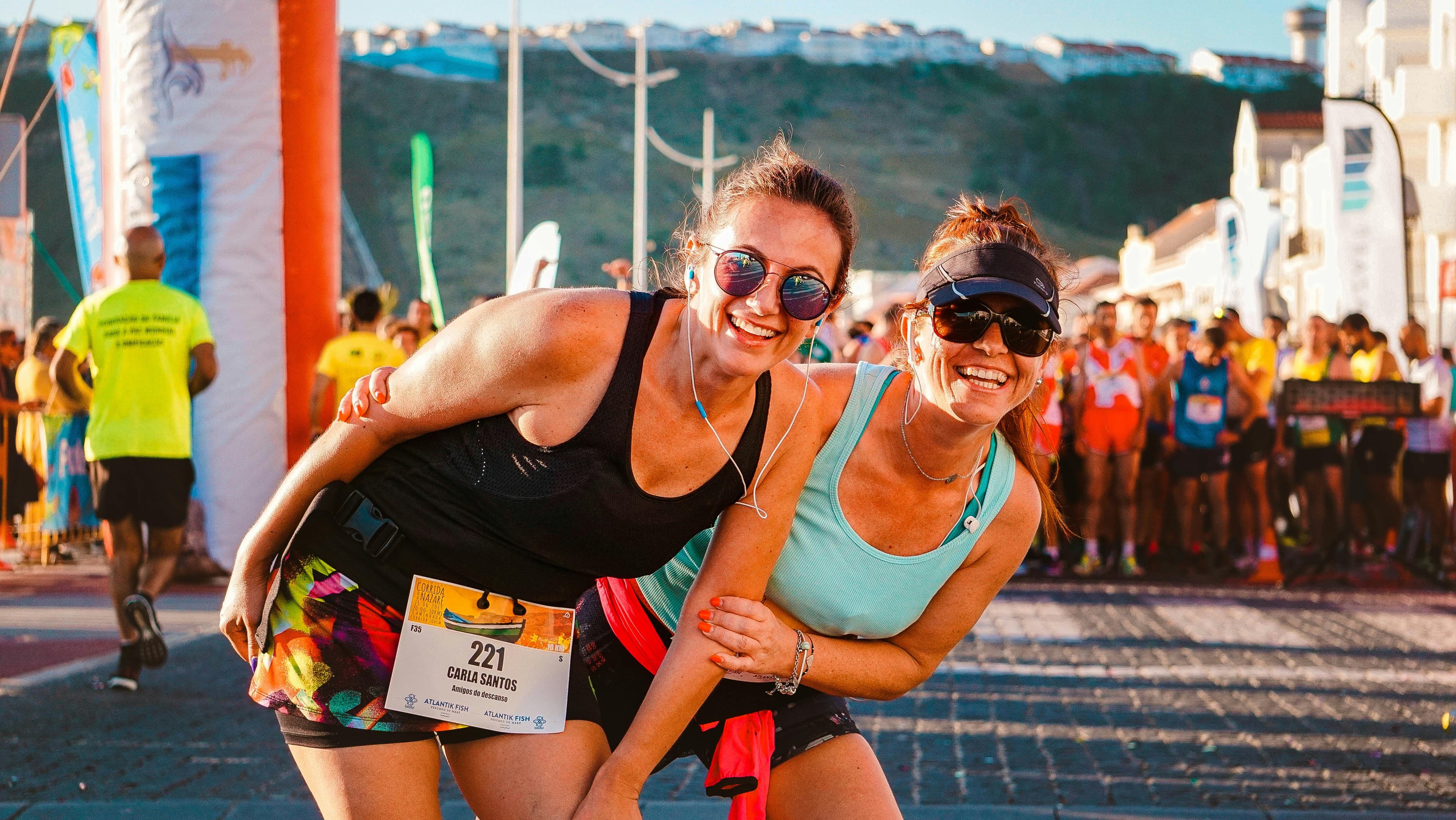 Runners celebrating together at a busy race event
