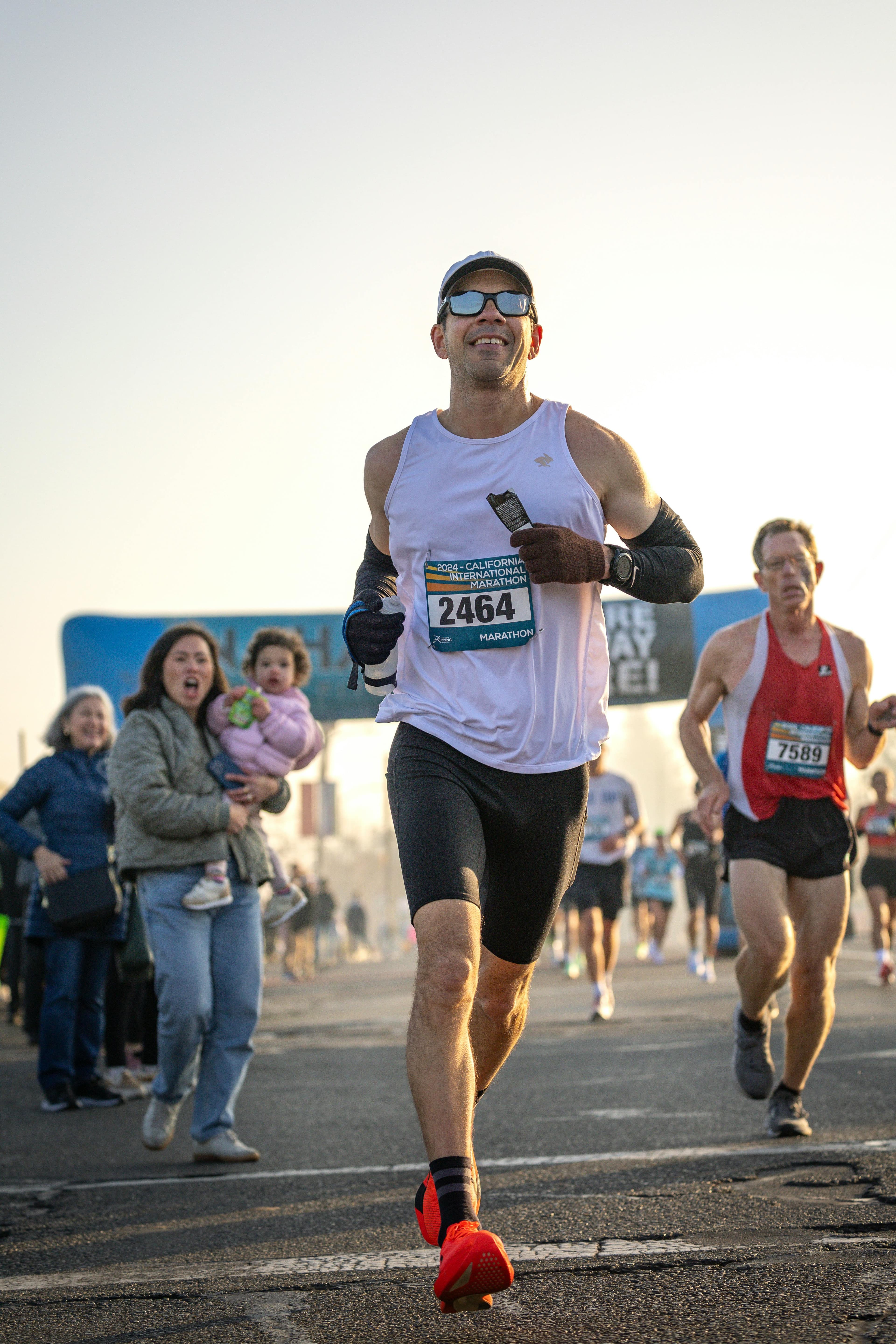 Runner pushing through a road race near the finish
